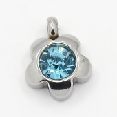 Colgante acero inoxidable flor con cristal facetado azul 9x7x4mm. Agujero 1,5mm